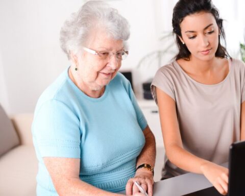 A Young Caregiver helping elder woman manage her money