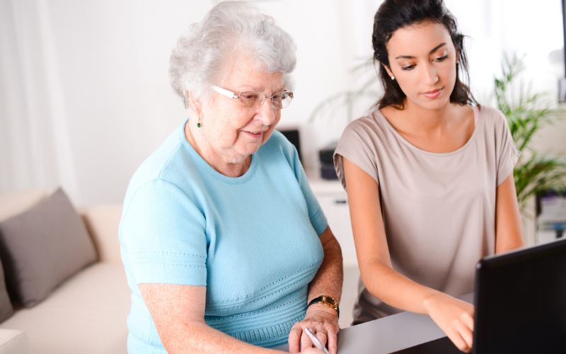 A Young Caregiver helping elder woman manage her money