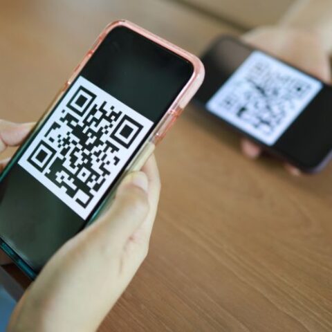 smart phone showing QR Code