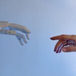 human hand reaching to touch robot hand