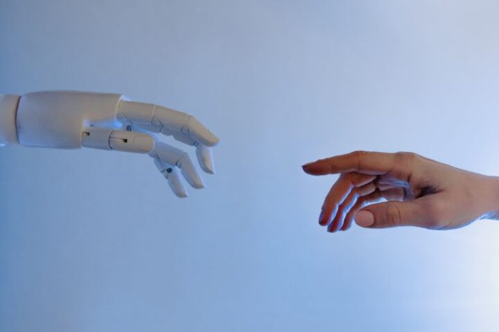 human hand reaching to touch robot hand