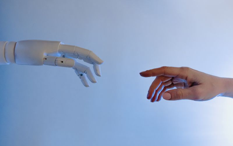 human hand reaching to touch robot hand