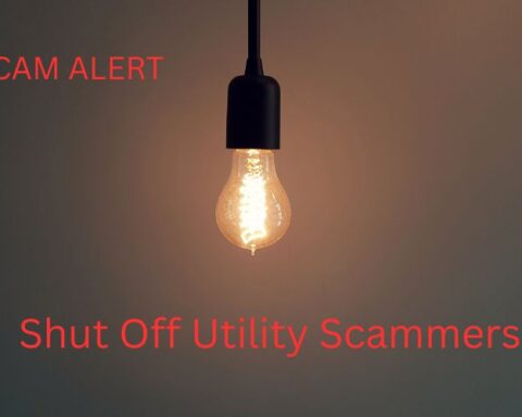 Single Light Bulb Hanging, Text reads Scam Alert. Shut Off Utility Scammers