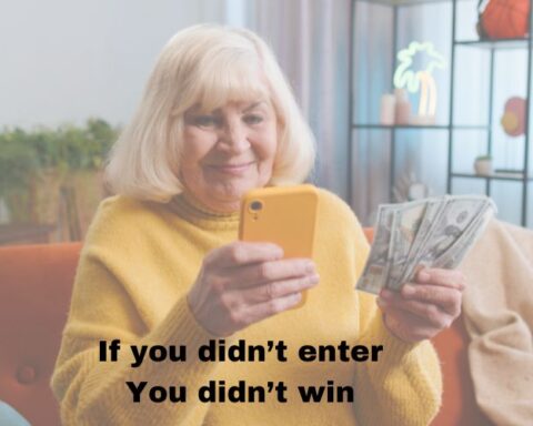 Older adult woman looking at her phone, with money in her hand